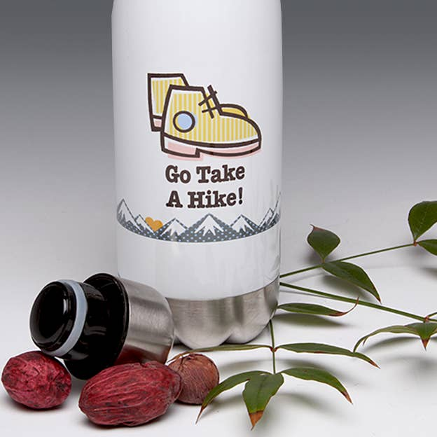White water bottle with yellow hiking shoe graphic, black lid, slogan 'Go Take A Hike!'.