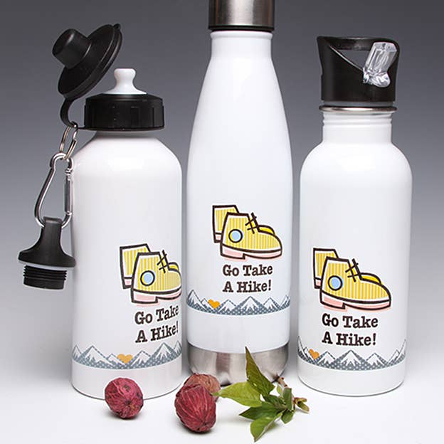 Three-bottle sampler set: white bottles with yellow hiking shoe graphics and black lids.