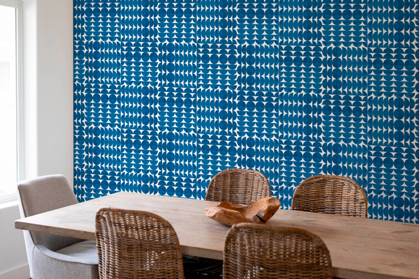 Blue geometric peel-and-stick wallpaper panel with small dot-and-triangle repeat