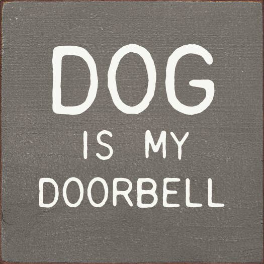 Decorative square wall sign with white text: DOG IS MY DOORBELL