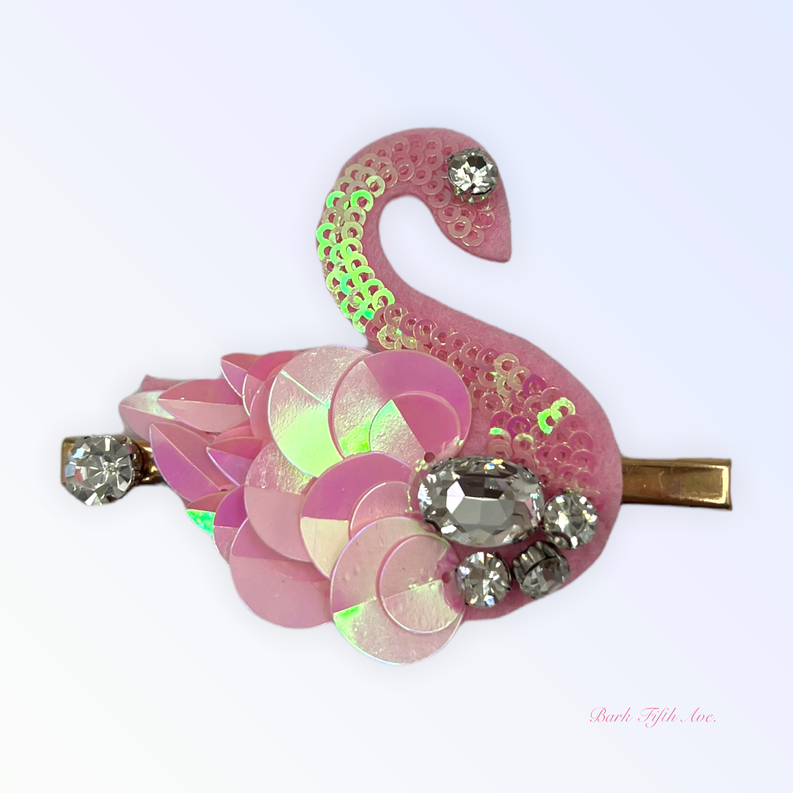 Pink sequin swan hair clip with layered petals and rhinestone accents on gold barrette