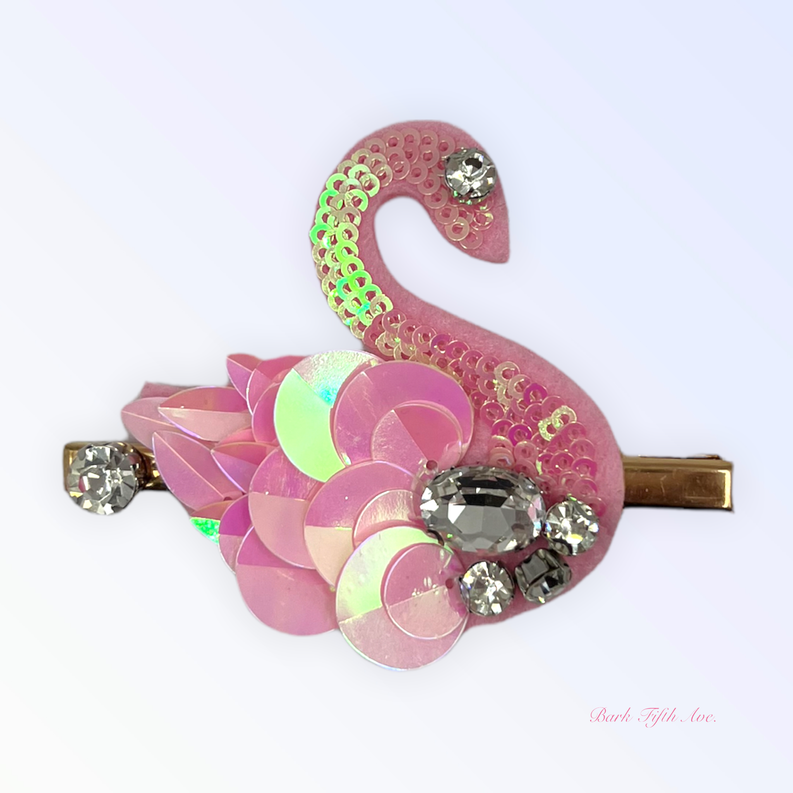 Pink sequin swan hair clip with iridescent petal layers and rhinestone stones on gold barrette