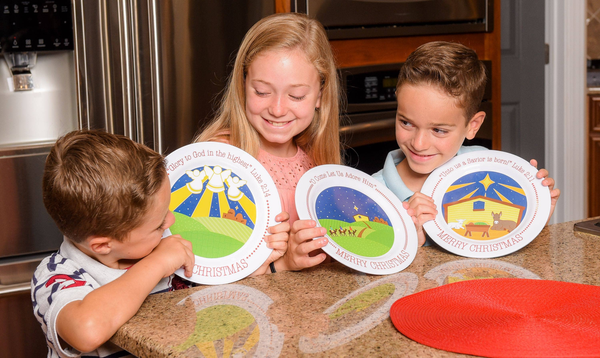 Round white Christmas manger plate with colorful nativity art and Merry Christmas text