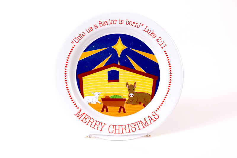Round white Christmas manger plate with blue nativity scene and red Merry Christmas lettering