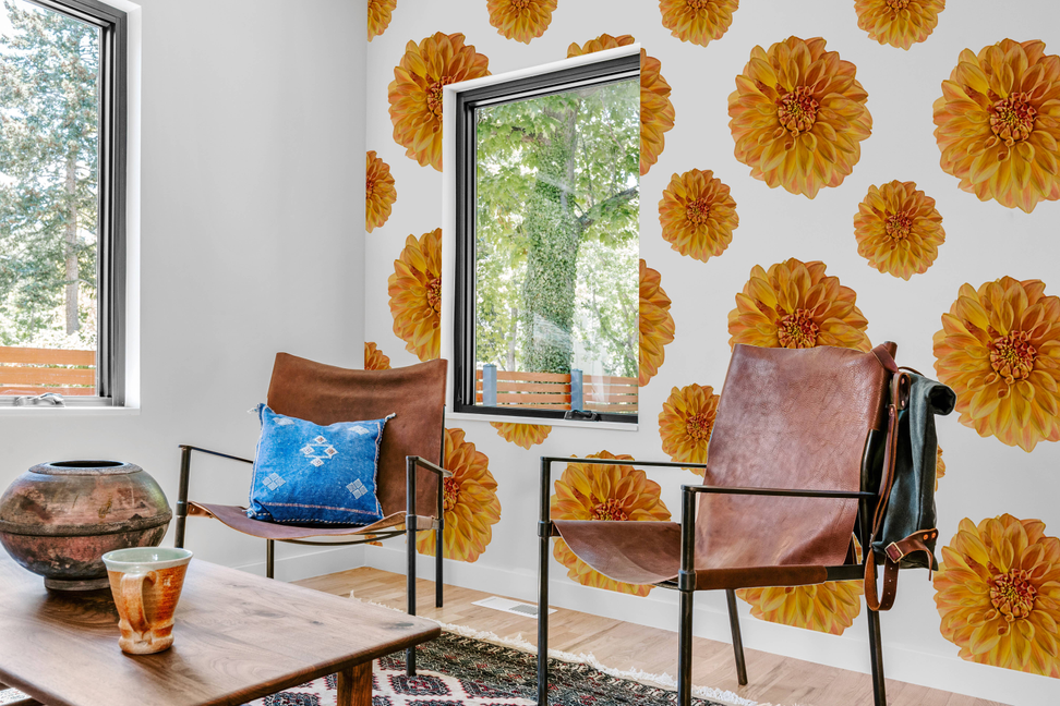 Floral peel-and-stick wallpaper panel with orange dahlia blossoms on a wall