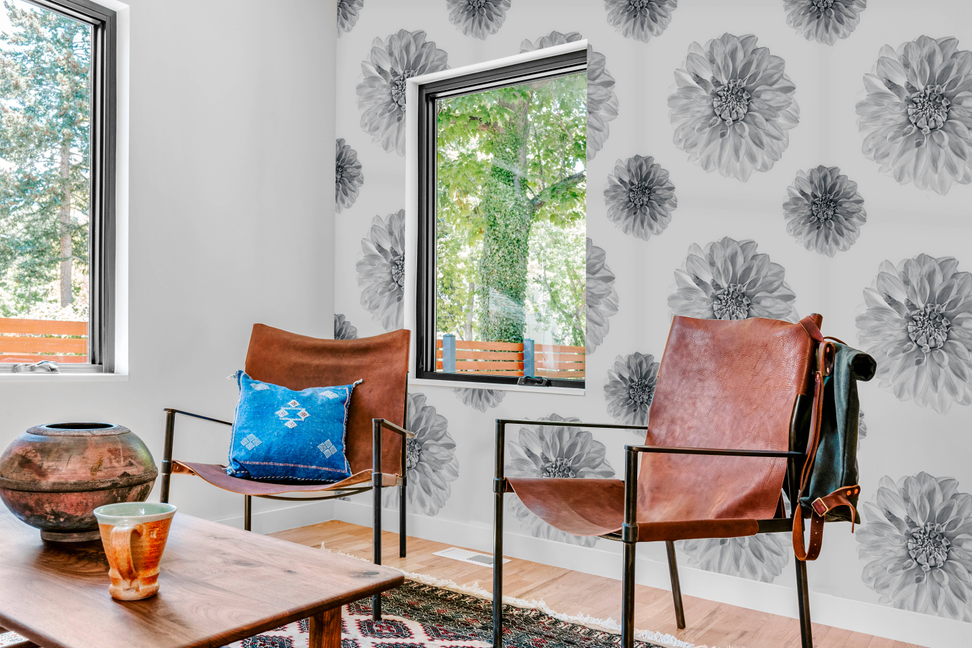 Floral peel-and-stick wallpaper panel covering an accent wall with gray flower pattern