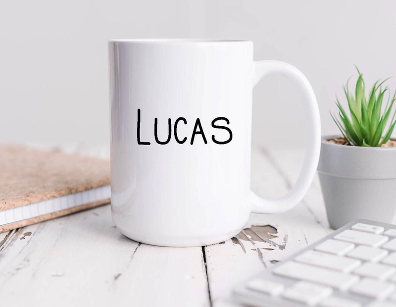 White coffee mug with name "LUCAS" printed on front and side handle
