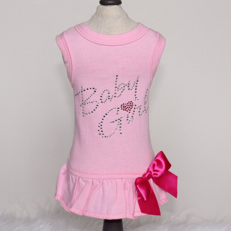 Pink sleeveless dress with sparkly 'Baby Girl' text and red bow at hem