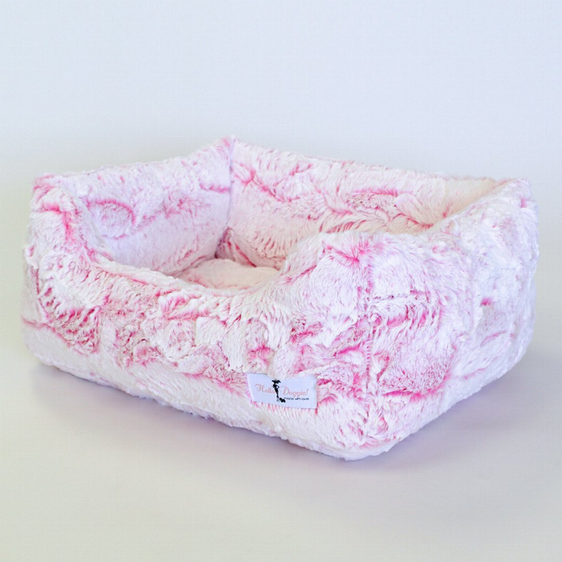 Plush rectangular dog bed with cushioned sides and speckled white-and-pink cover