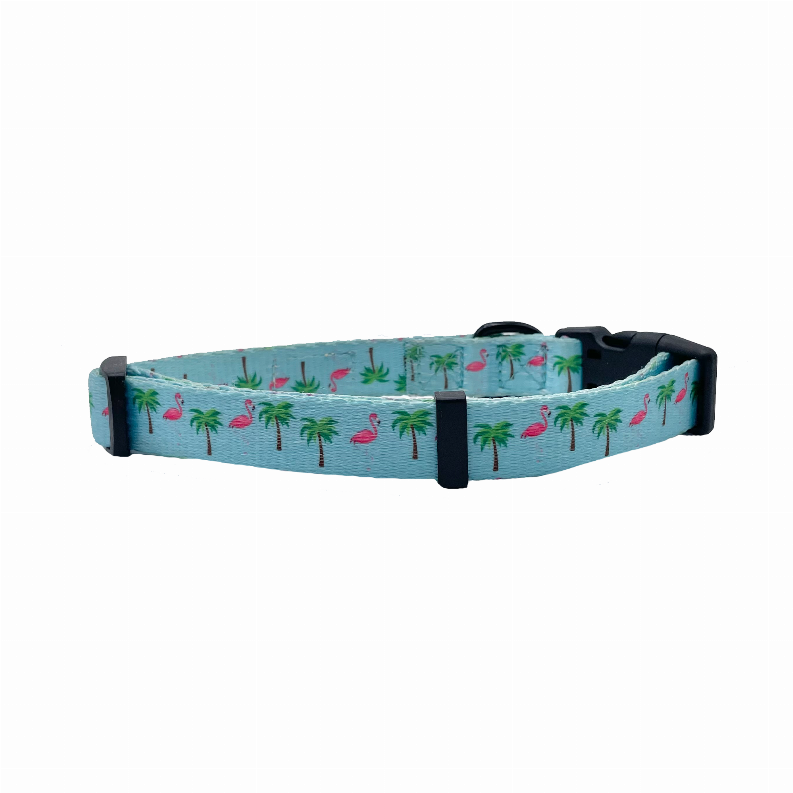 Side view of light blue dog collar with flamingos and palm trees and black clasp hardware