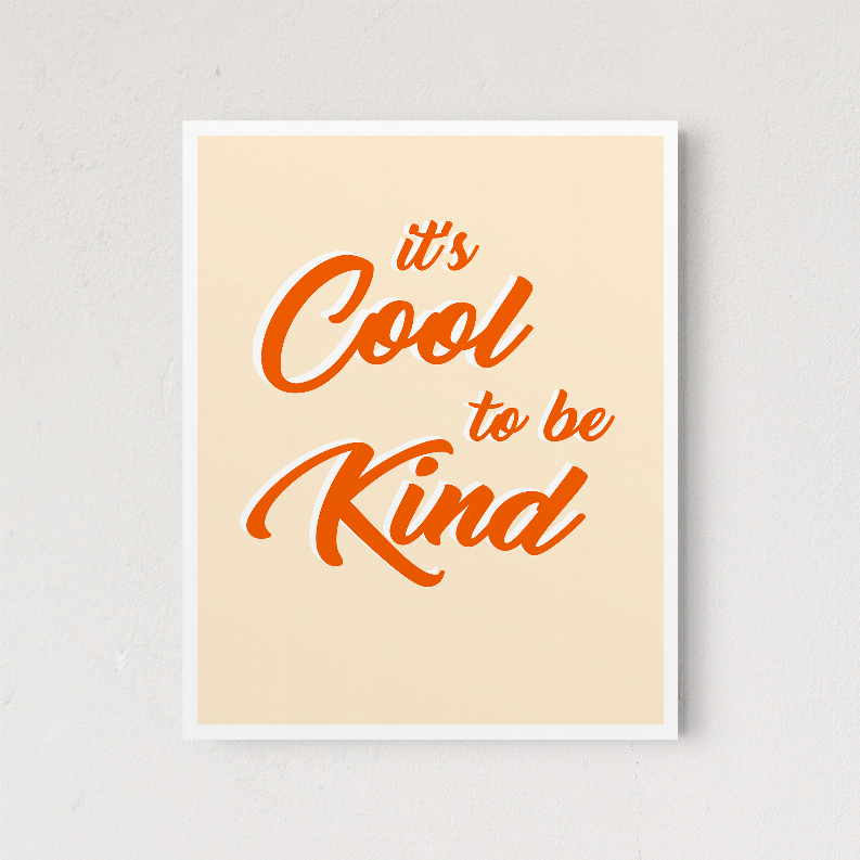 Framed wall art print featuring orange text "It’s Cool to be Kind"