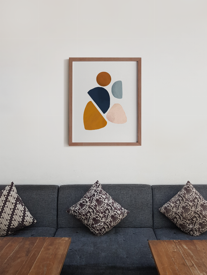 Wood-framed abstract wall art featuring orange, navy, light blue and blush geometric pieces