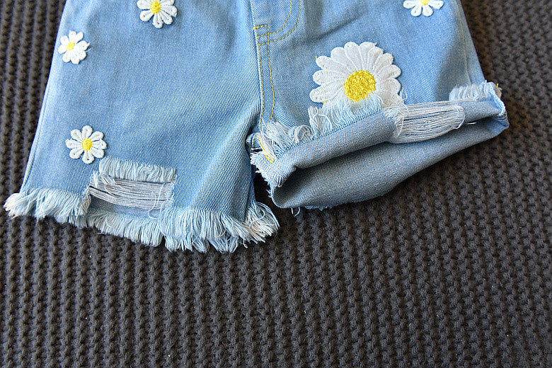 Girls light-blue denim shorts with daisy embroidery and frayed hem, cuffed look