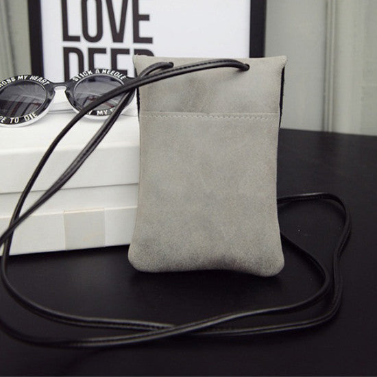 Light gray matte dusty crossbody bag with black strap and simple front panel