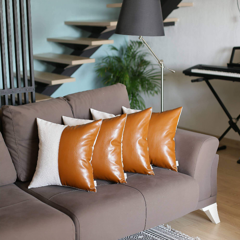 Set of 4 throw pillows featuring glossy orange faux leather fronts and white cushions