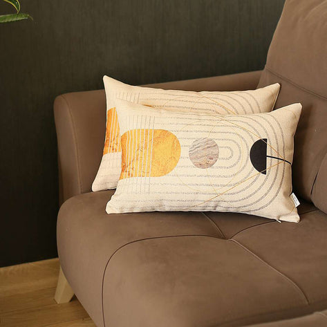 Two jacquard throw pillow covers with geometric circle print in mustard, gray, and black