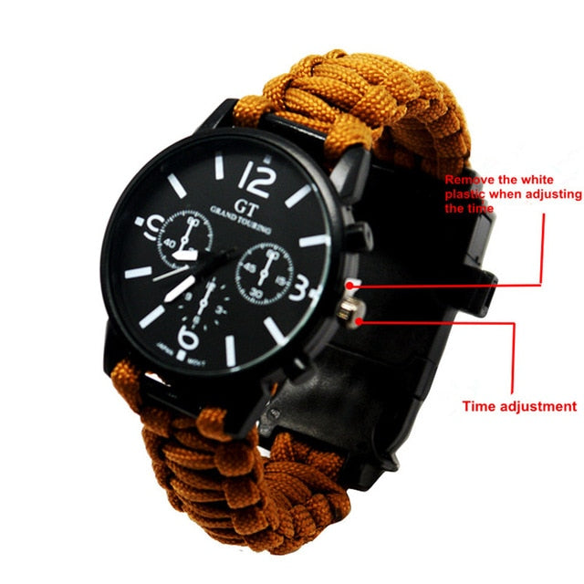 Analog survival watch close-up with black dial, subdials, tan paracord band