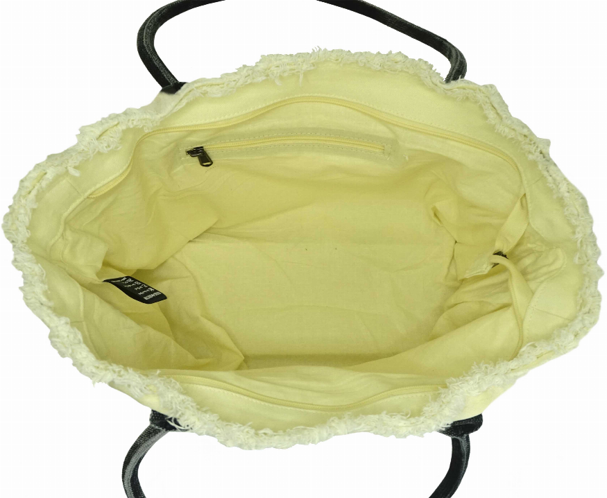 Light yellow-green tote bag interior with top zip pocket and black trim