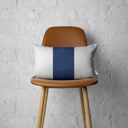 White faux leather pillow cover with bold navy vertical stripe, rectangular