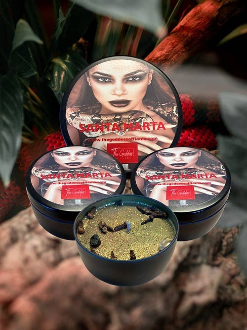 Scented candle set with three round tins and one open cup; glittery wax surface