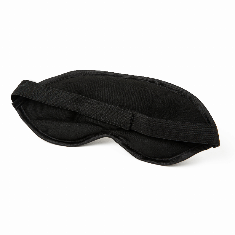 Black sleep mask with wide elastic band laid flat