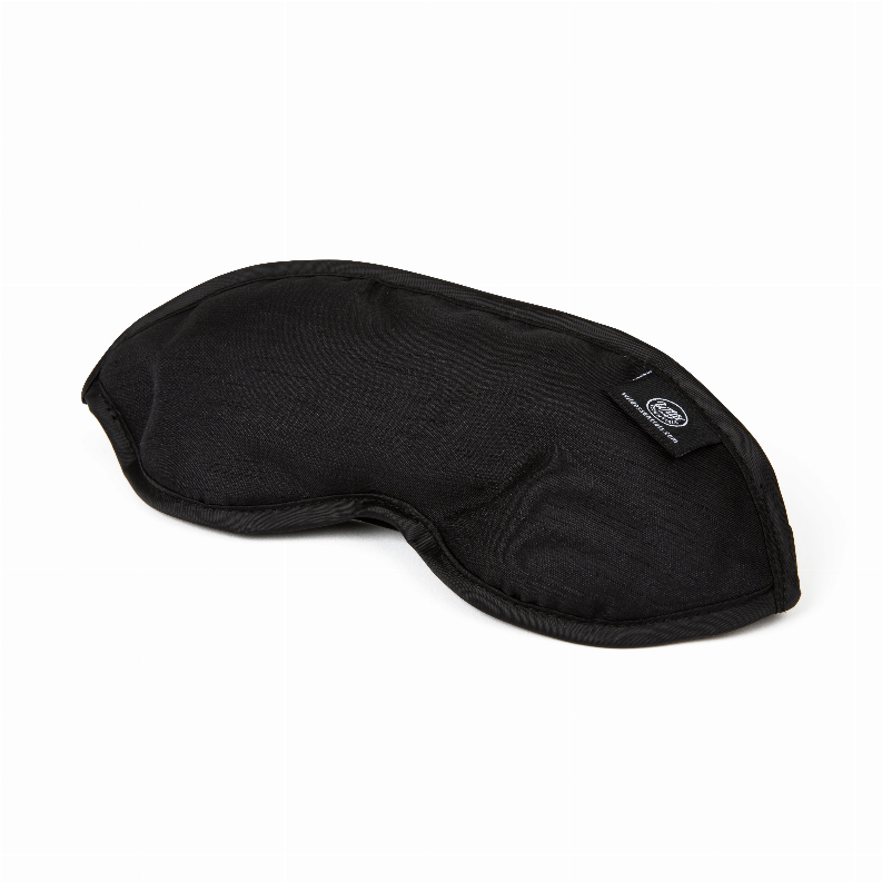 Black contoured sleep mask with small brand patch on outer corner