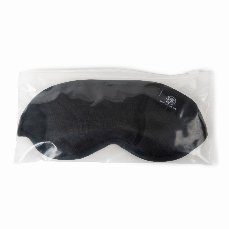 Black contoured sleep mask inside a clear plastic sleeve with logo patch