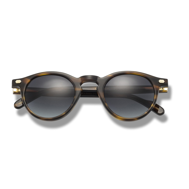 Round dark tortoiseshell sunglasses with gold-tone temples and tinted lenses
