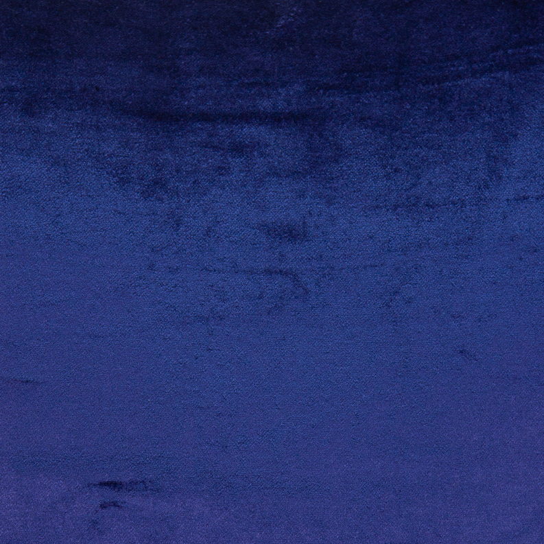 Royal blue velvet-like throw pillow fabric close-up with subtle mottled texture.