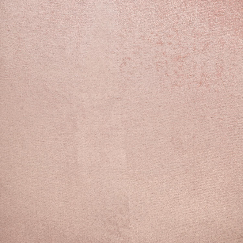 Close-up of pink throw pillow fabric texture with subtle mottled pattern.