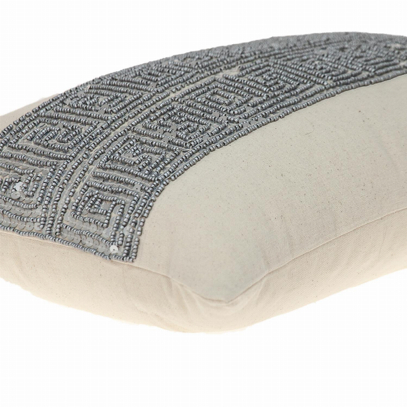 Side view of cream pillow with blue-gray sequined geometric trim on seam