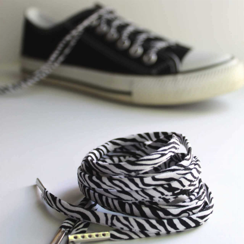 Zebra-print shoelaces with silver aglets, black-and-white striped coil