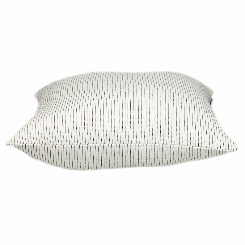 Square throw pillow with light cream cover and thin vertical dark stripes, side profile