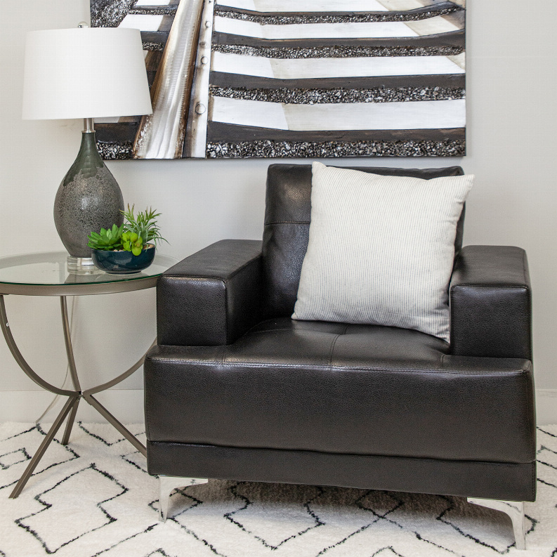 Square throw pillow with light cream cover and thin vertical dark stripes