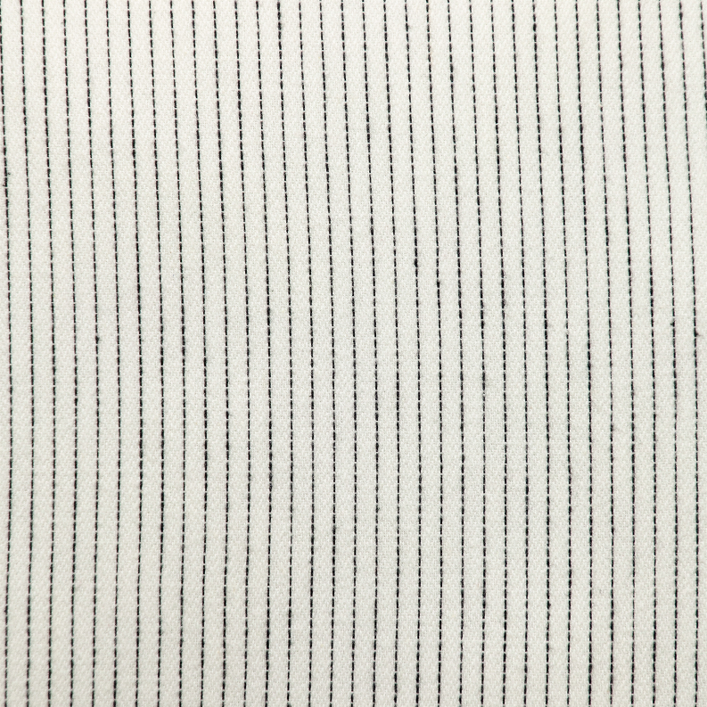 Light cream pillow fabric with thin vertical dark pinstripe texture