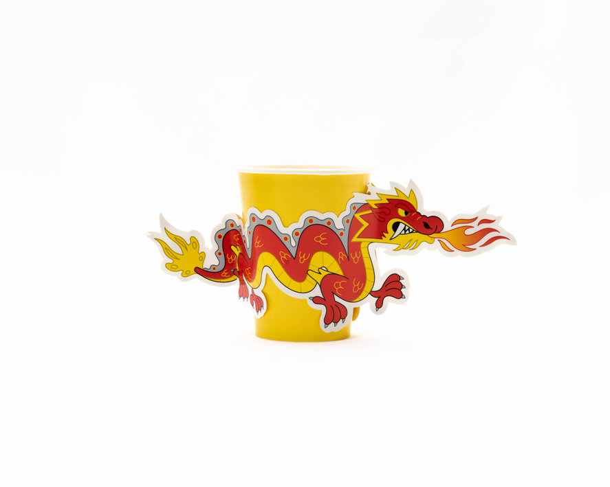 Yellow paper cup with red dragon graphic and white rim