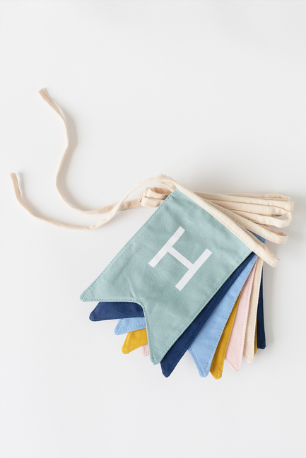 Pastel fabric pennant banner with letter 'H' on triangular flags