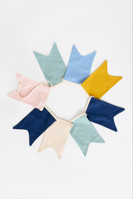Pastel triangular fabric pennants fanned out for birthday garland