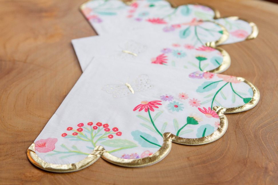 Floral scalloped napkins with gold-edged heart cutout design