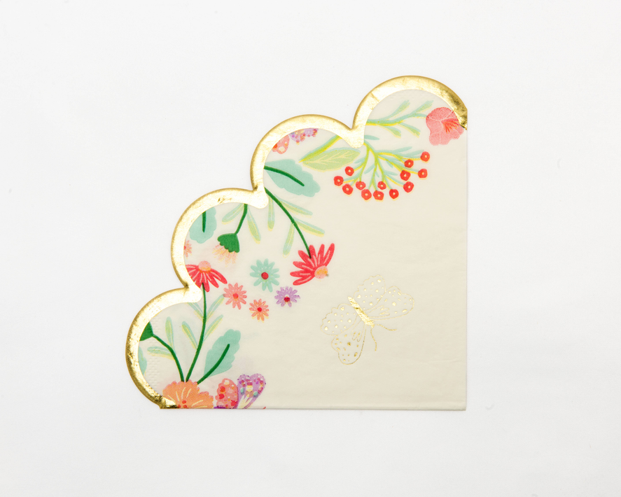 Heart-shaped floral scalloped napkin with gold trim and white background