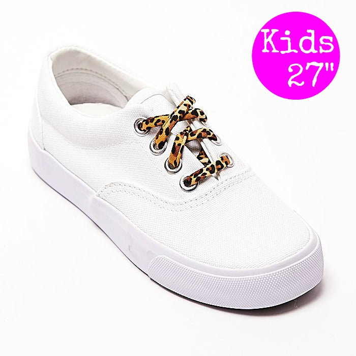 White canvas sneakers with leopard-print shoelaces and metal eyelets