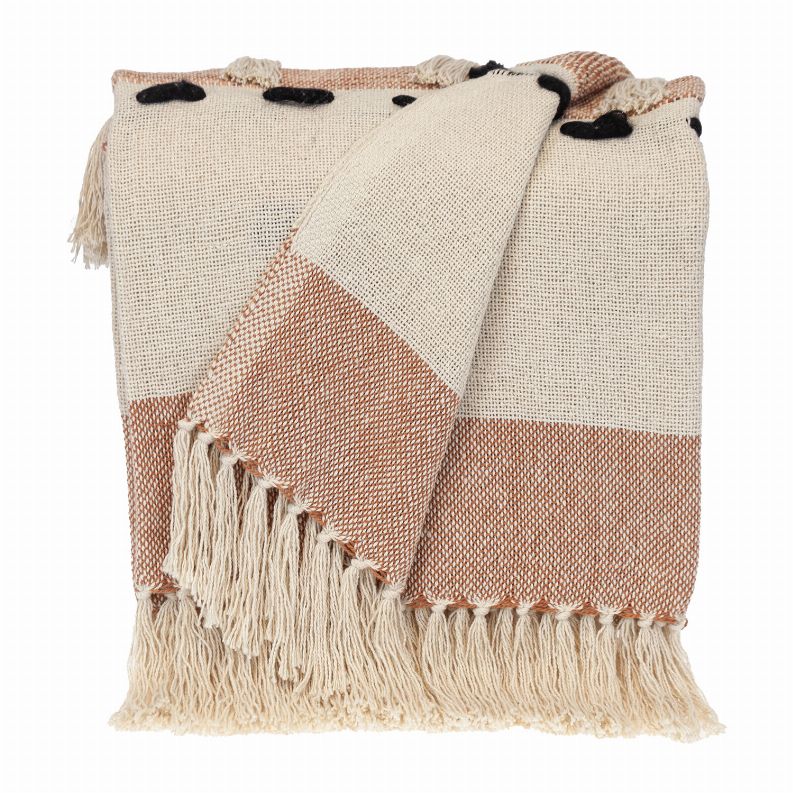 Cream and terracotta woven throw blanket with fringe edges and small black dot accents