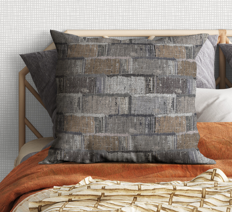 Gray and tan patterned square pillow with textured brick-block design
