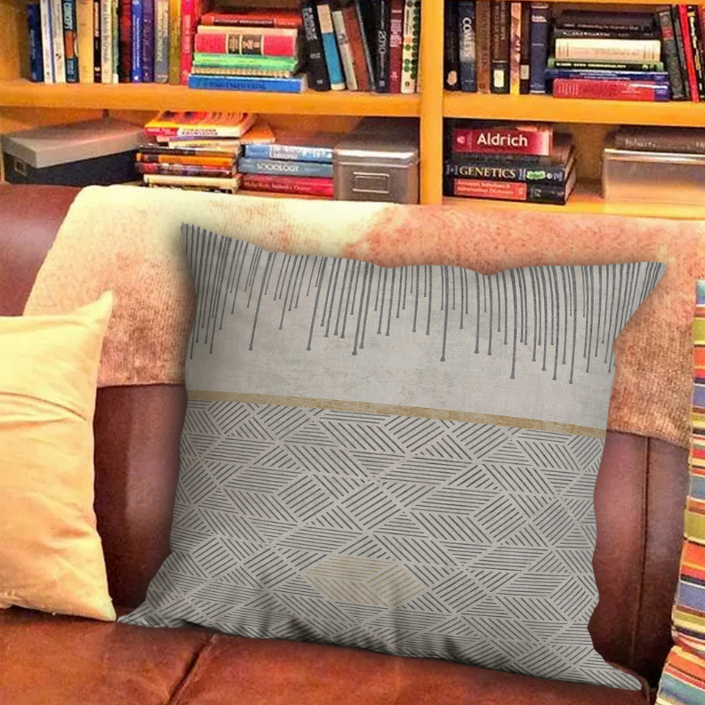 Decorative square pillow with gray ruler-mark stripes and woven geometric base.