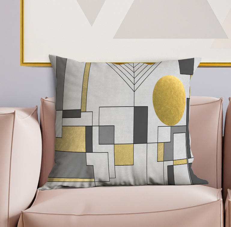 Gray geometric decorative pillow with gold oval, black shapes, and layered square pattern