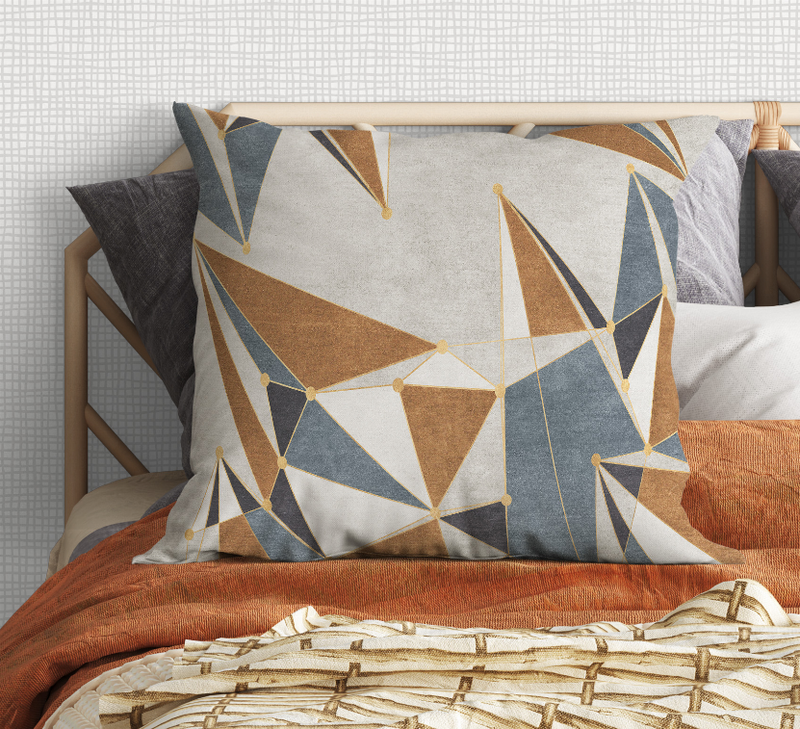 Geometric throw pillow with gray-blue background and brown and cream triangle line pattern