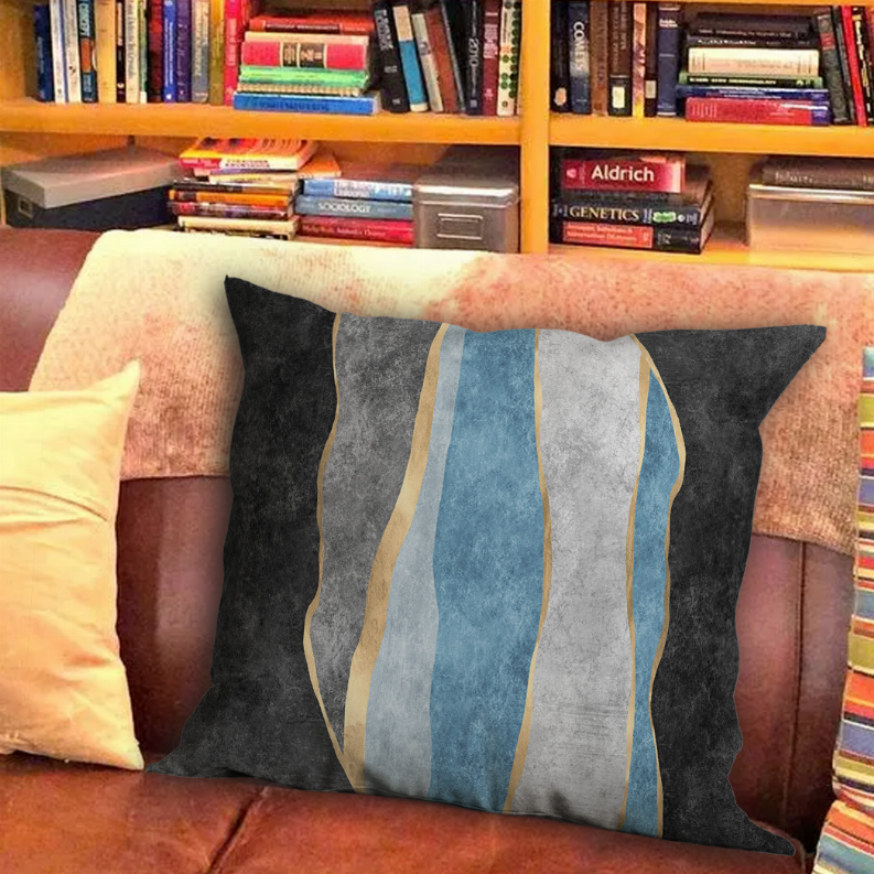 Rectangular charcoal pillow with curved vertical stripes in blue, gray, and beige