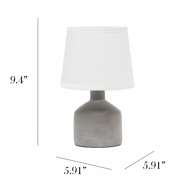 Gray ceramic table lamp with white fabric drum shade and compact round base