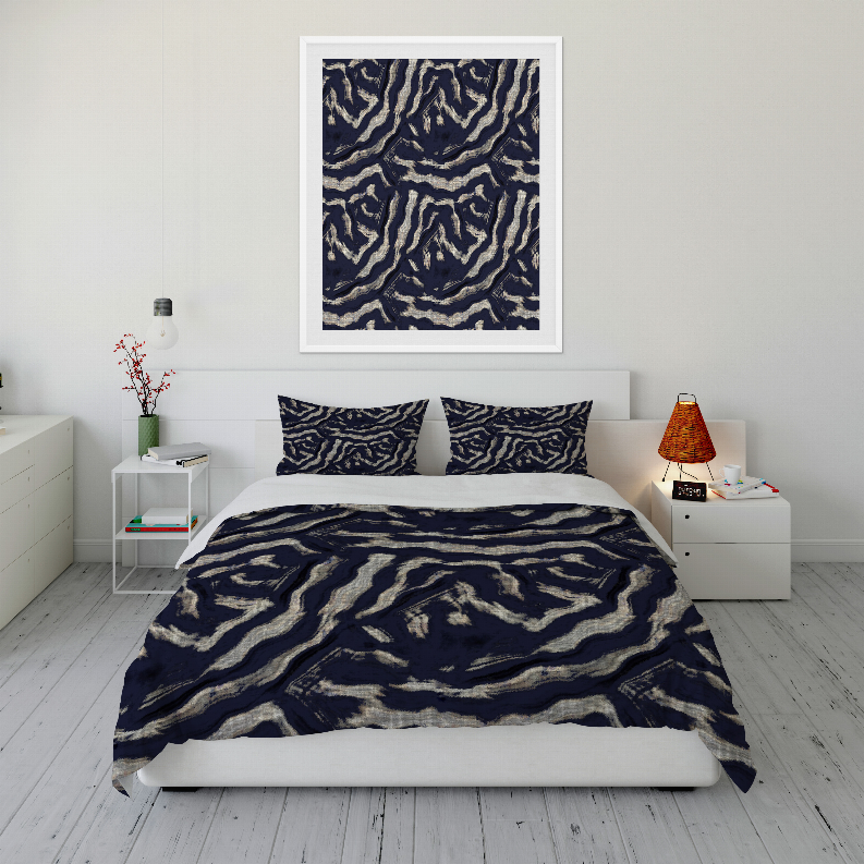 Navy and cream abstract swirl comforter with two pillow shams on bed