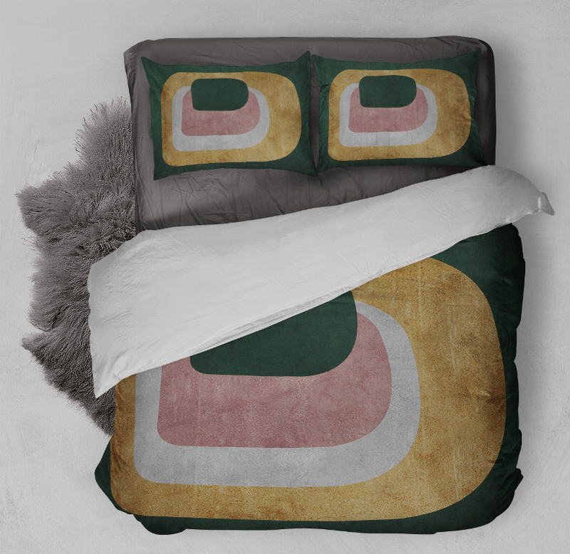 Comforter and pillow set with green, tan, and pink abstract geometric blocks